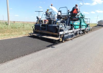 Coughlin Company repaving a rural road with recycled asphalt pavement.